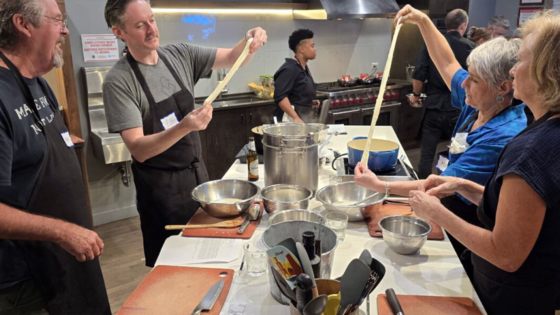 the-chopping-block-cooking-class-students-stretching-mozzarella