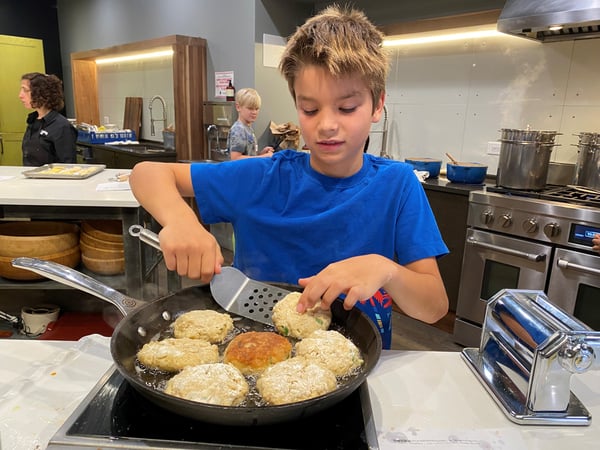 Kid Flipping Crab Cakes