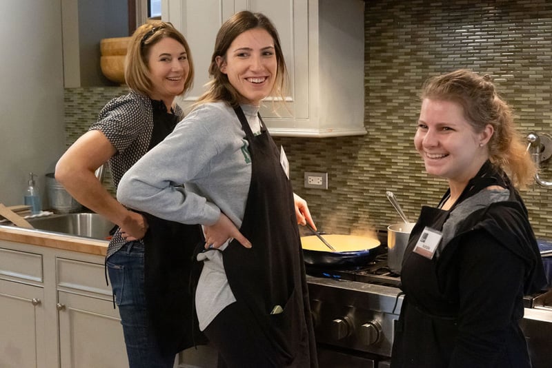 3 Women Smiling at Stovetop