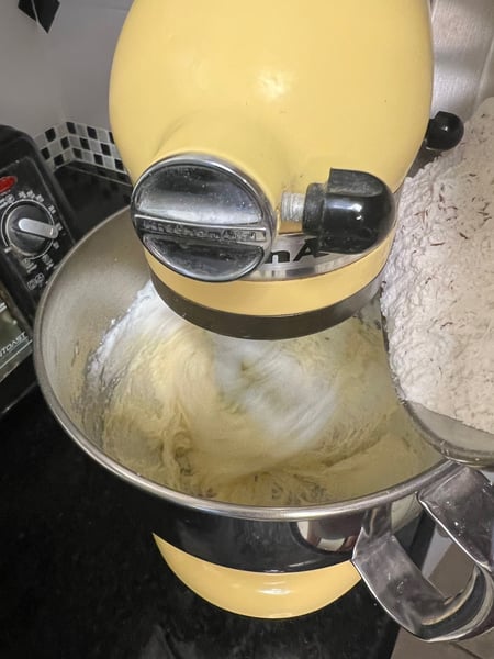 adding dry ingredients in mixer