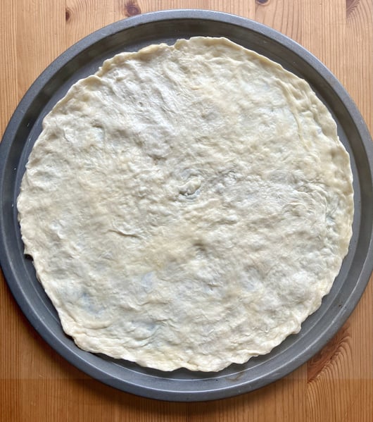 Pizza dough in pan