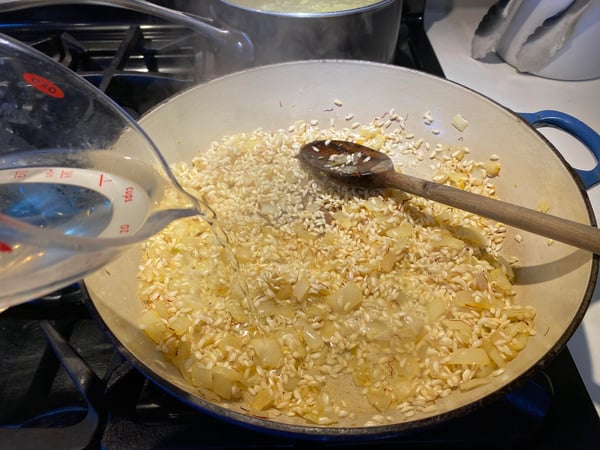 adding stock to risotto