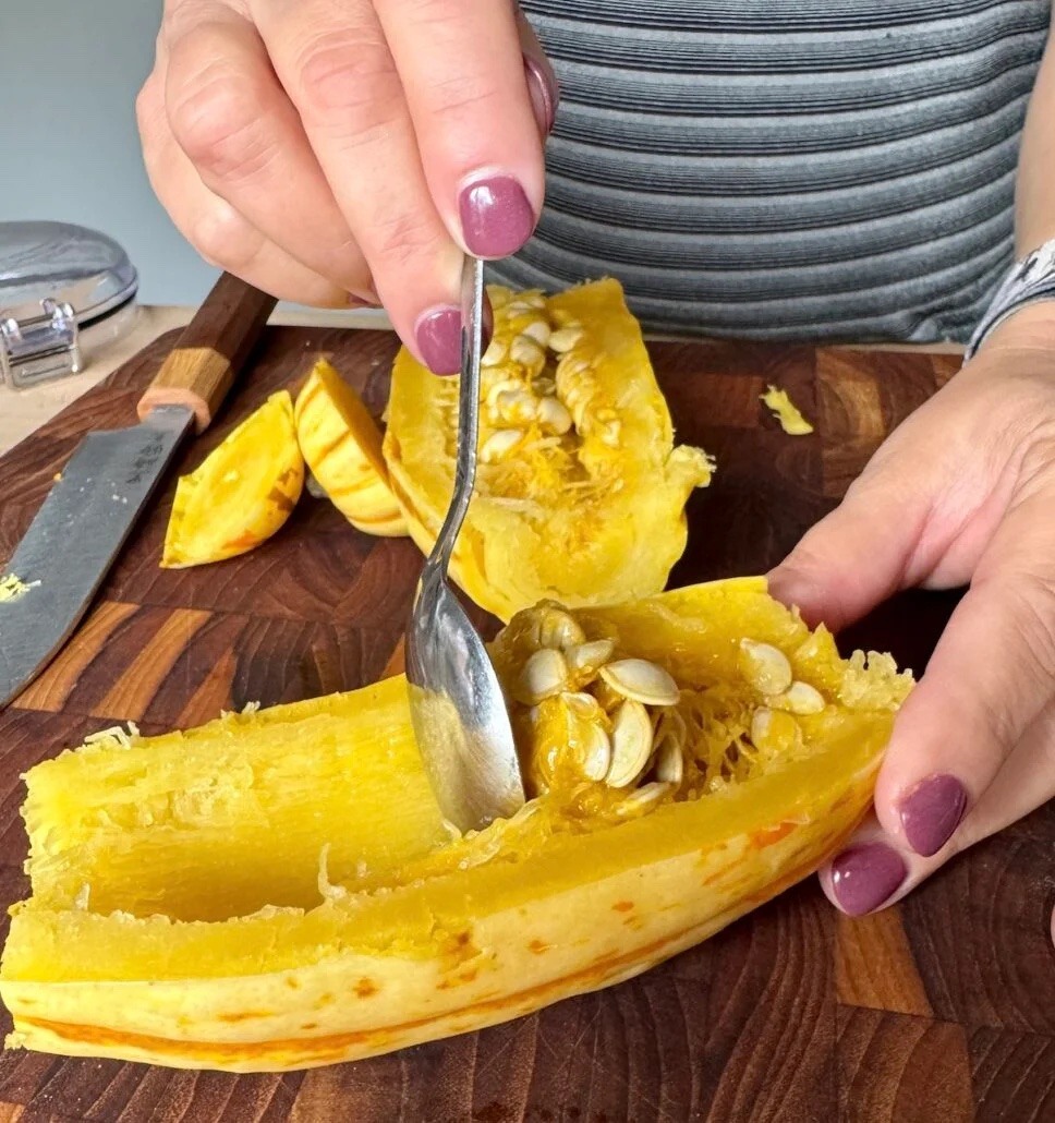 Scooping delicata squash