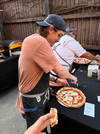 Tim slicing pizza