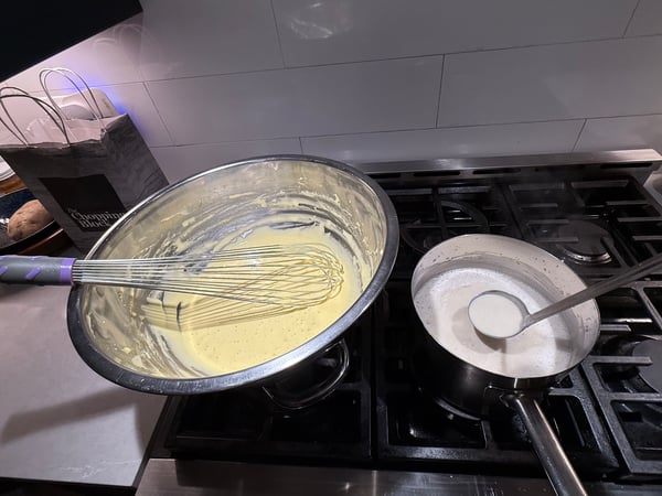 Adding cream to yolks