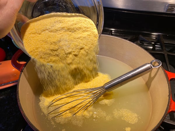 adding polenta to liquid