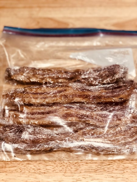 bacon wrapped in plastic in freezer bag