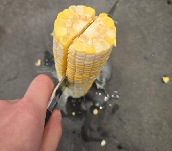 Slicing corn in half