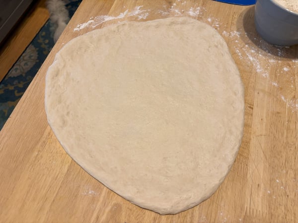 Pizza dough shaped