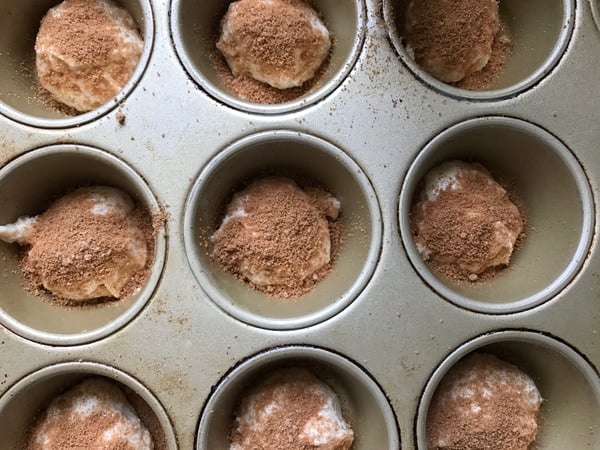 dough in muffin tin with brown sugar