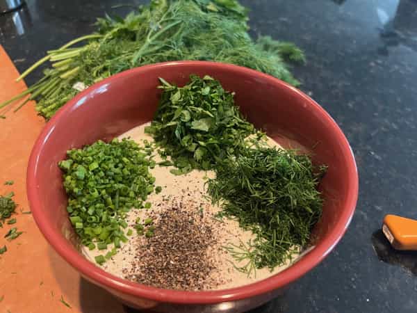 Dressing in bowl with herbs