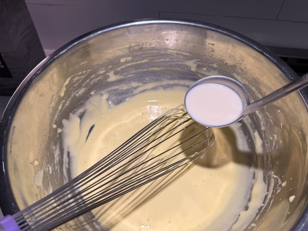 Ladle of cream to yolks