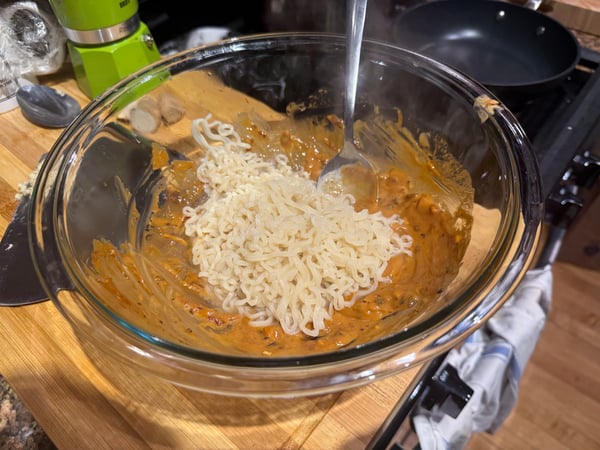 Cooked noodles on sauce