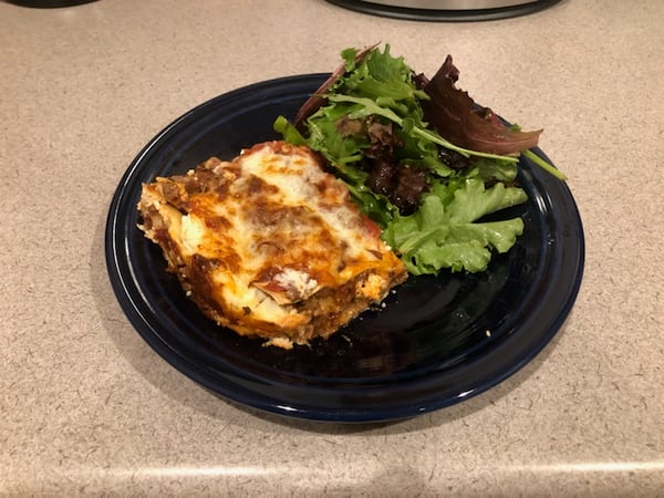 plated lasagna with salad