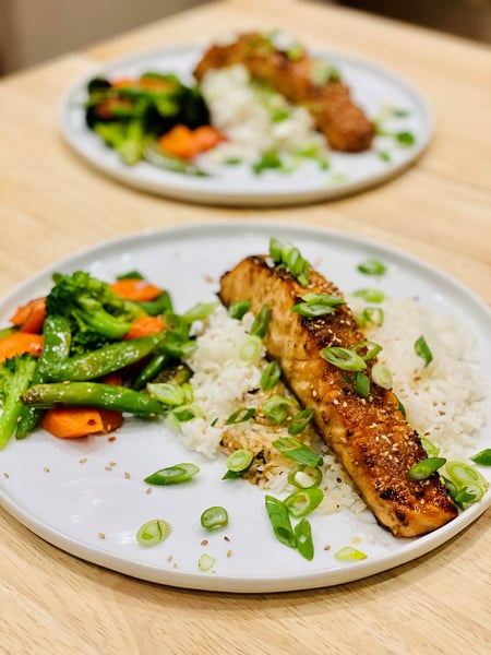 plated salmon with rice and stir fried veggies