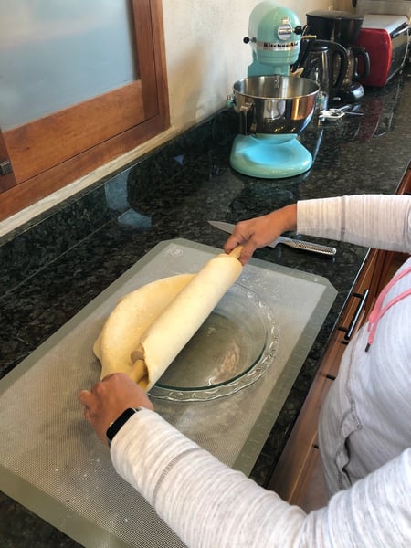 rolling out dough in pan