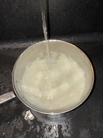 Tap running over rice