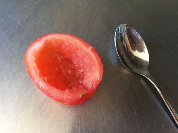 seed tomato with a spoon