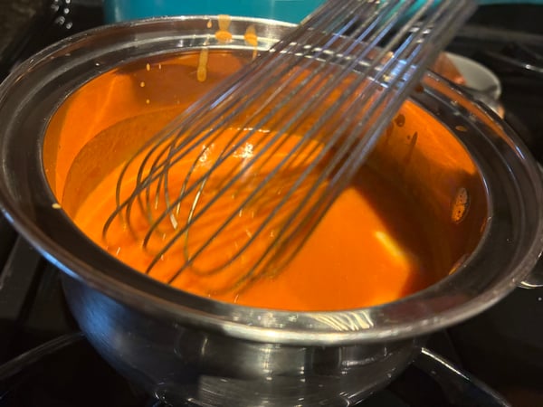 Whisking buffalo sauce