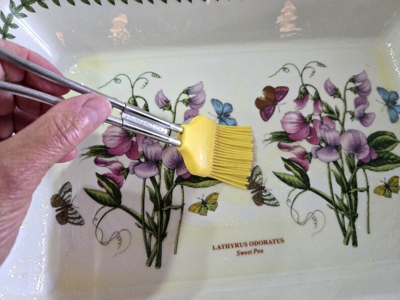 Brushing dish with butter