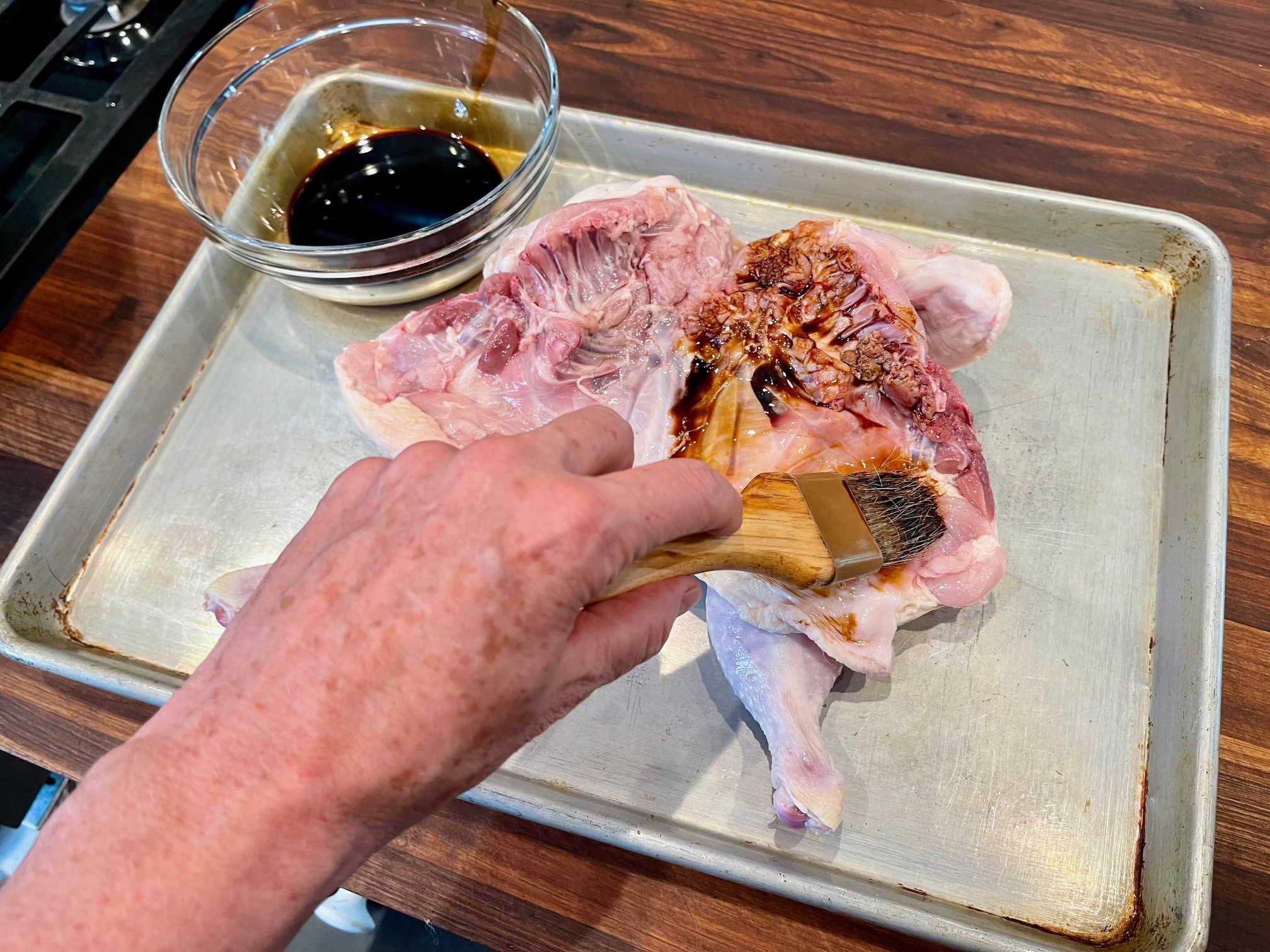 Brushing chicken with soy