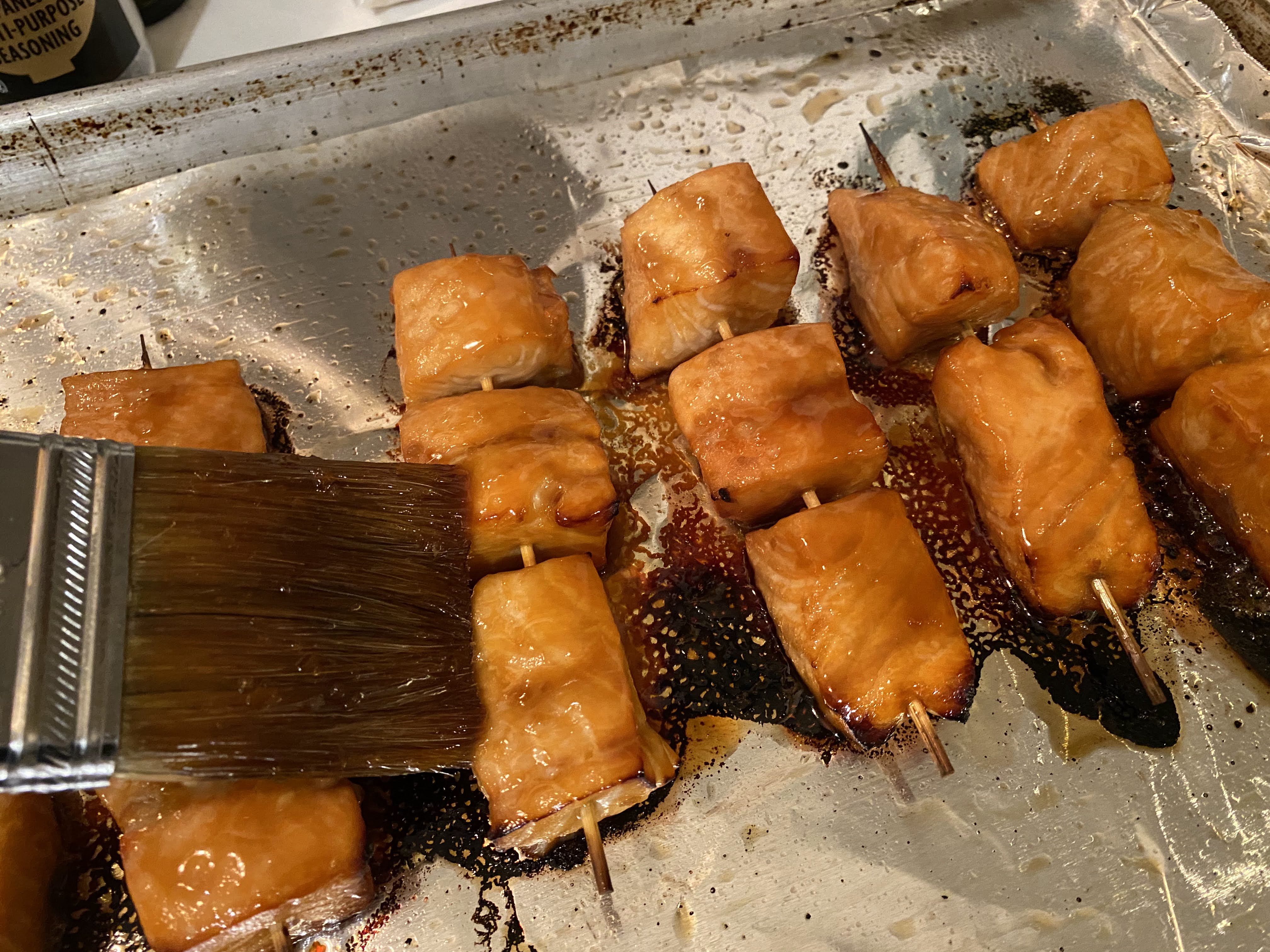 Brushing salmon skewers