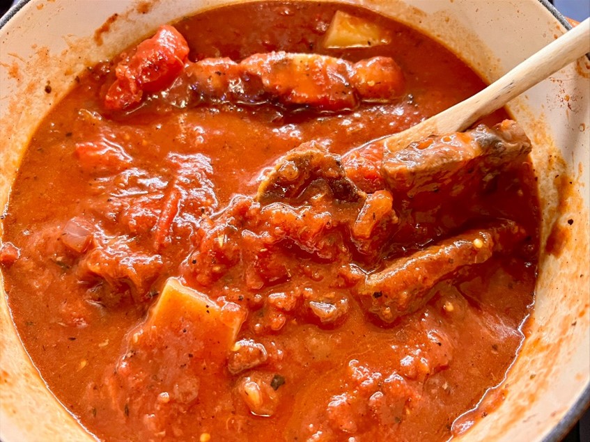 Meat simmering in sauce