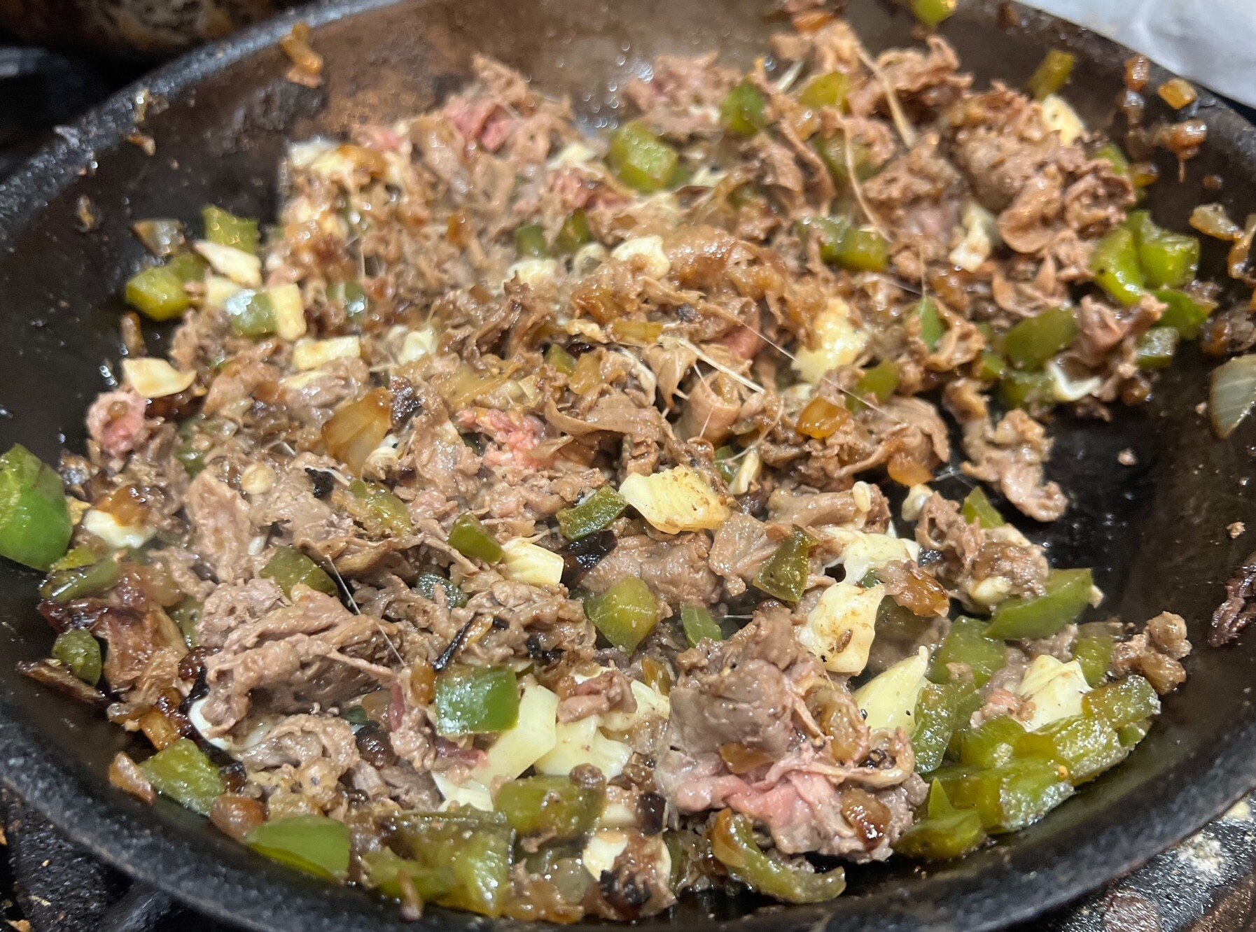 Melted cheese with steak and onions and peppers