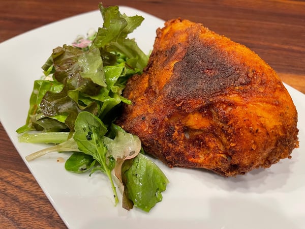 plated fried chicken with salad