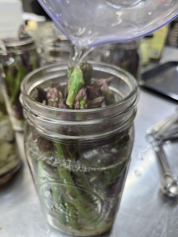 Pouring brine into jars