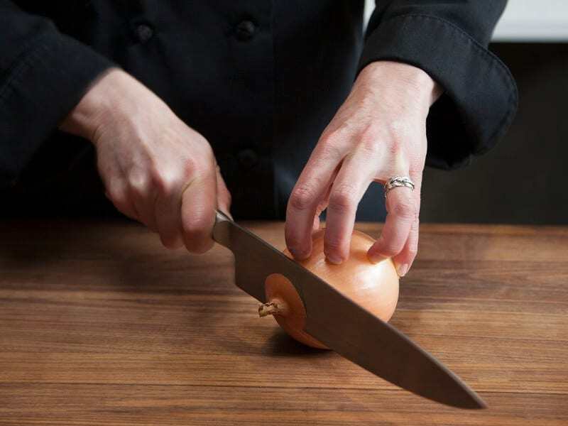 hands chopping onion