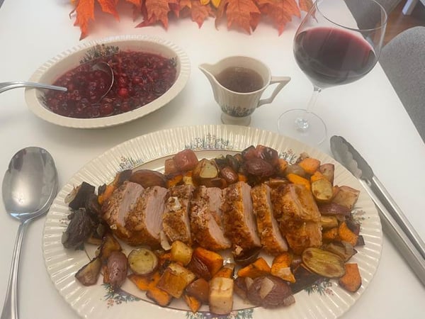 Plated meal with wine and cranberry sauce